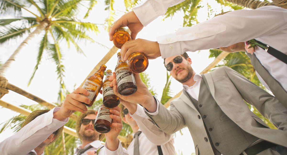 Group of Men Raising Bottles